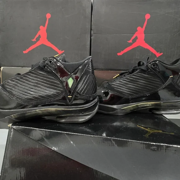 This is a pair of Air Jordan 2009 'S23' sneakers in the black and metallic gold